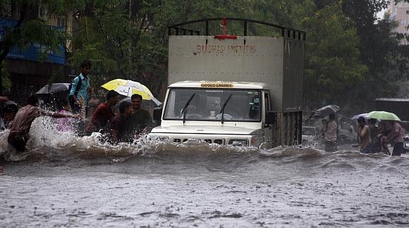 A truck wades through a water-logged street in Thane