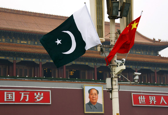 A Pakistan national flag flies alongside a Chinese national flag in front of the portrait of Chairman Mao Zedong on Beijing's Tiananmen Square