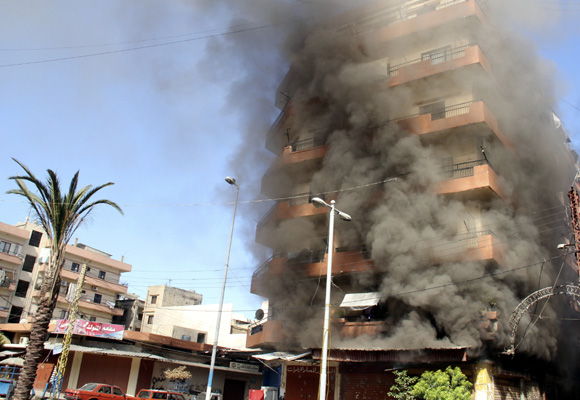 Smoke rises from a residential building at the Sunni Muslim dominant neighbourhood of Bab al-Tebbaneh in Tripoli, northern Lebanon, during clashes between Sunni Muslims and Alawites