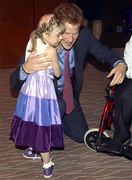Prince Harry speaks with Hope Hillis as he attends the WellChild awards ceremony