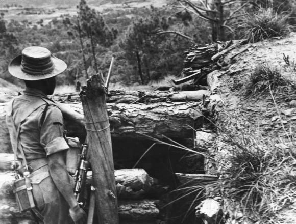 An Indian soldier stands guard over makeshift forts which have been hastily built in the Ladakh region during border clashes between India and China. Photo taken in November 1962