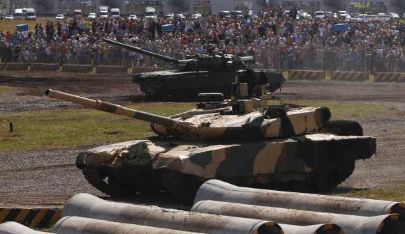A Russian T-90MS tank and a T-90 tank are seen at a firing ground during a demonstration show