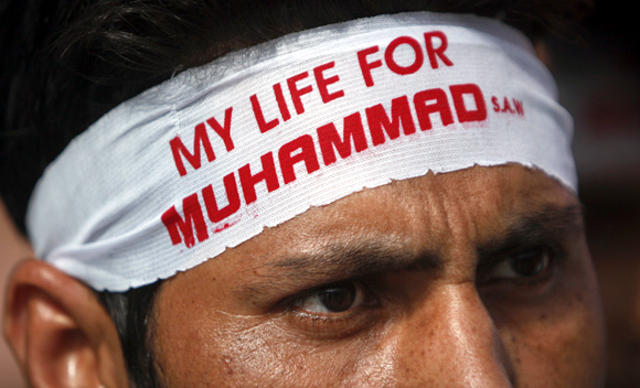 A protestor  wears a headband during a protest march towards the US consulate in Karachi