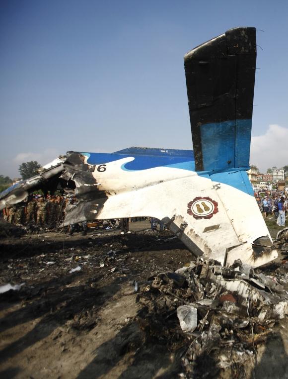 The wreckage of a Dornier aircraft, owned by private firm Sita Air, is seen as a rescue team investigates at its crash site in Kathmandu