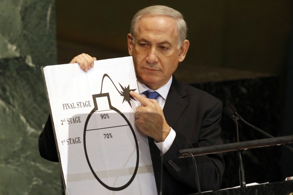 Israeli Prime Minister Benjamin Netanyahu holds an illustration describing Iran's ability to create a nuclear weapon as he addresses the 67th United Nations General Assembly