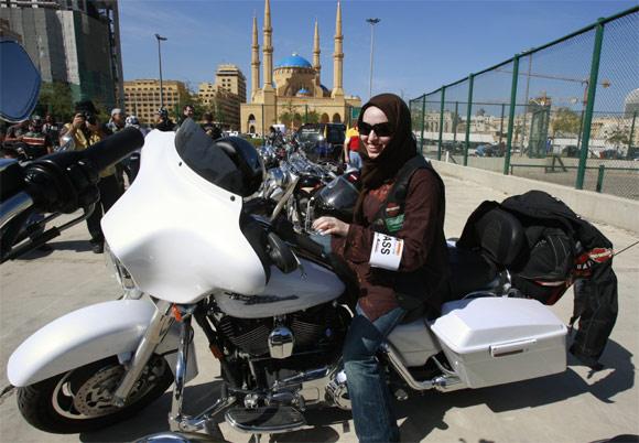 A female Harley-Davidson owner from Saudi Arabia sits on her bike in downtown Beirut before the start of the first Lebanon Harley Tour