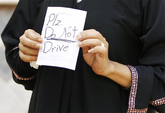 Female driver Azza Al Shmasani displays a note, which according to her, was placed on her car by an unknown person, in Saudi Arabia