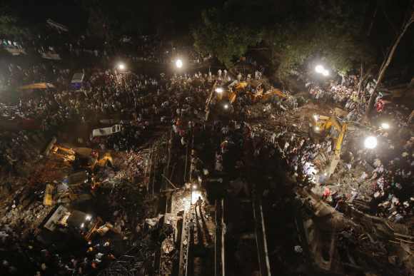 Rescue workers search for survivors at the site of the crash in Thane