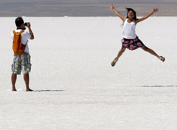 A tourist poses for pictures at Tuz Golu (Salt Lake in Turkish), which is the second biggest lake in Turkey, located in the Central Anatolia Region