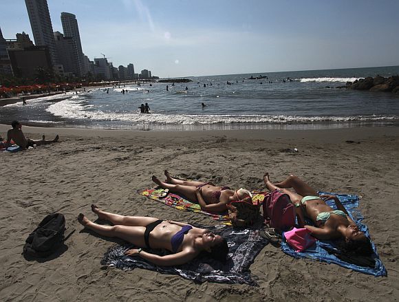Tourists relax at Bocagrande beach in Cartagena, Colombia