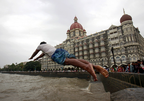 A man jumps into the Arabian Sea in front of Taj Mahal Hotel