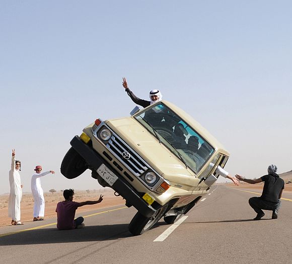 Saudi youths demonstrate a stunt known as