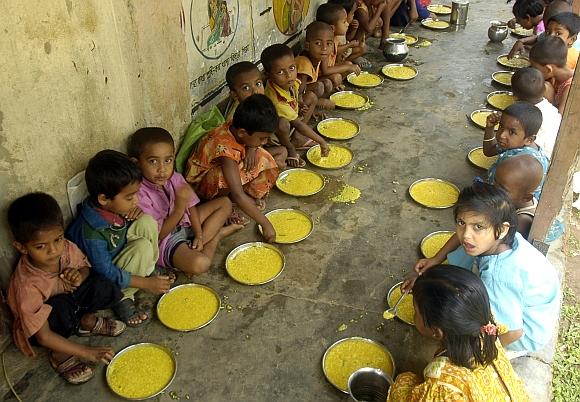 Students have a free meal distributed by a government-run school in Nalchar village, 70 km south of Agartala, Tripura