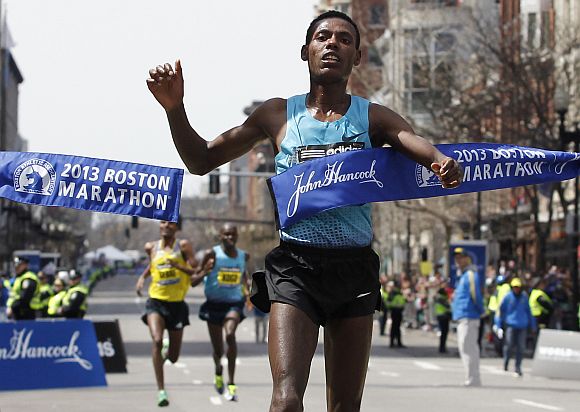 Lelisa Desisa Benti of Ethiopia crosses the finish line to win the men's division of the 117th Boston Marathon