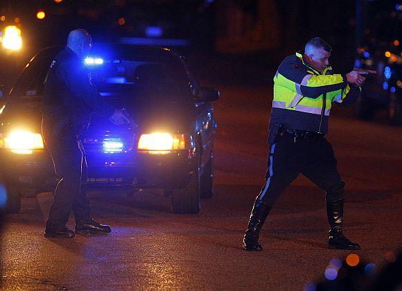 Police officers keep a man on the ground in Watertown