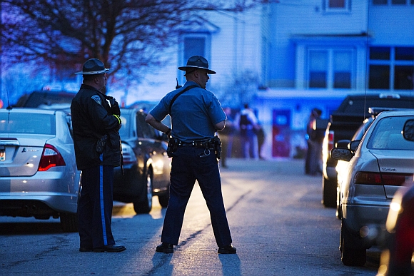 Law enforcement officials stand at the scene on Franklin St. as the search comes to an end in Watertown, Massachusetts