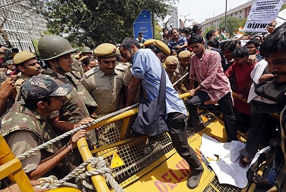 Demonstrators try to cross a police barricade during a protest