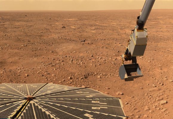 NASA's Phoenix Mars Lander's solar panel and the lander's robotic arm with a sample in the scoop are seen in this image taken on Mars.