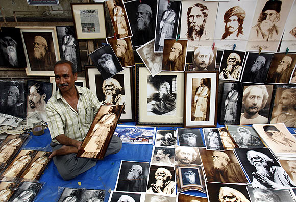 A street vendor sells photographs of Rabindranath Tagore, who wrote the Jana Gana Mana, on a pavement in Kolkata