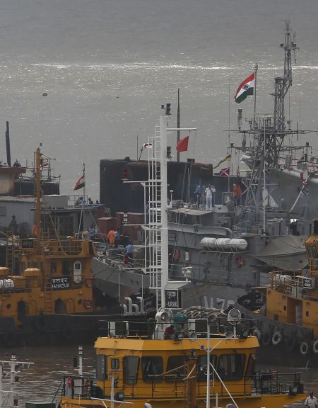 Ships and a submarine belonging to Indian Navy are seen docked at the naval dockyard in Mumbai on Wednesday