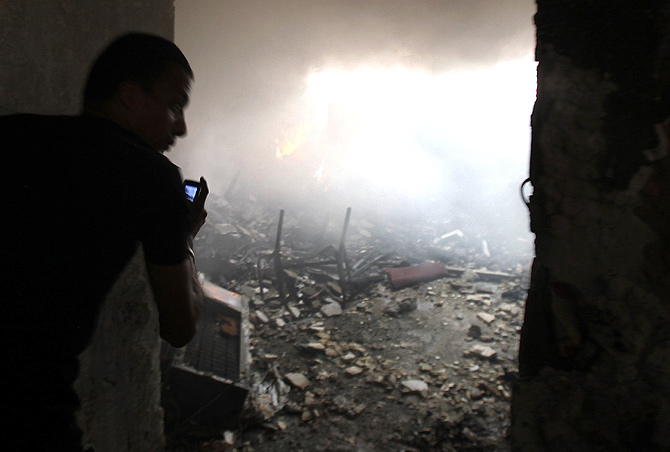 A man uses a phone to record events in the Rabaa Adawiya mosque complex 