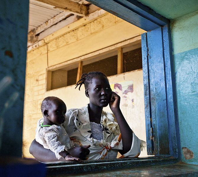 A Sudanese woman and her child wait for test results at a hospital
