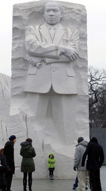 A child has her picture taken at the Martin Luther King, Jr Memorial in Washington, DC.