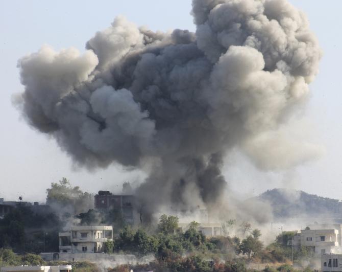 Smoke rises after what activists said was shelling by forces loyal to Syria's President Bashar al-Assad