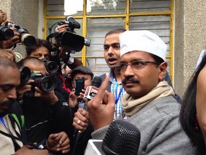 Aam Aadmi's Arvind Kejriwal shows his inked finger to the media after he cast his vote