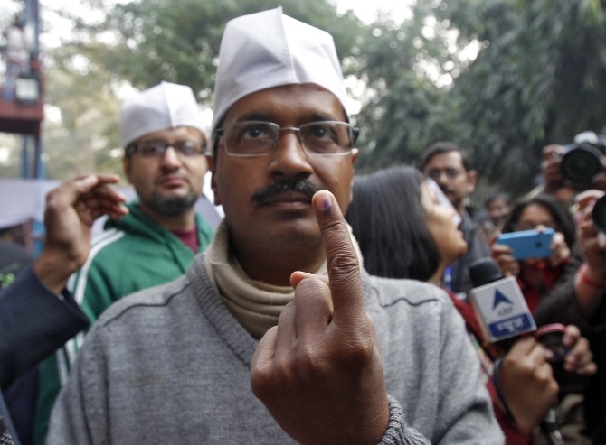 Kejriwal shows his ink-stained finger after casting his vote