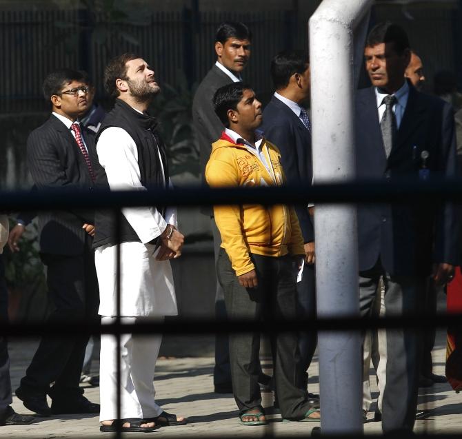 Rahul Gandhi waits in a queue to cast his vote outside a polling station during the state assembly elections in New Delhi 