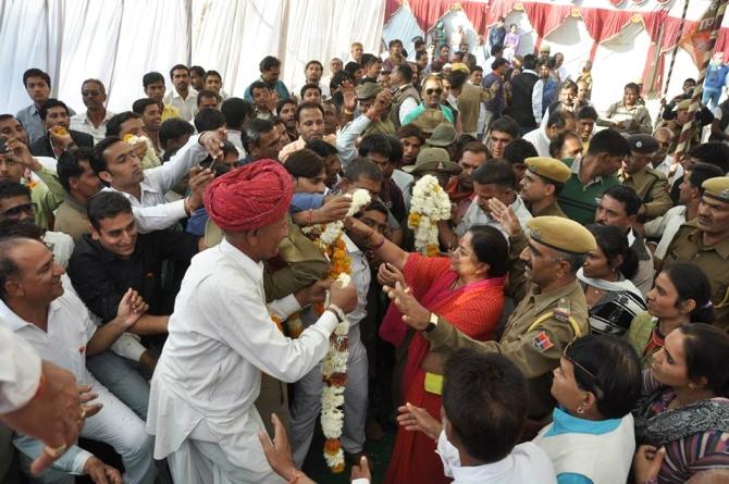 Vasundhara Raje is greeted by supporters at a rally