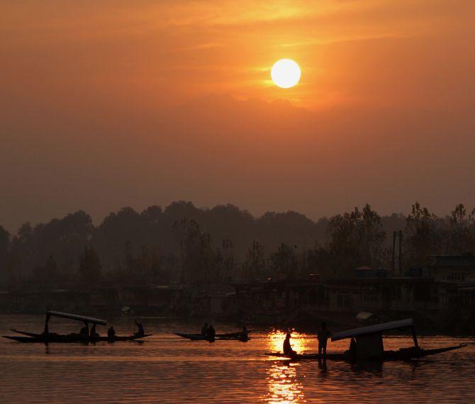 Tourists enjoying shikara rides on Dal Lake during sunset. Srinagar is yet to receive its first snowfall this season