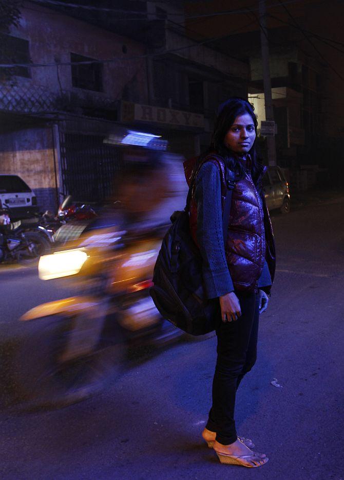 Sheetal, 23, who works at a night call centre, poses for a photograph outside her office in New Delhi