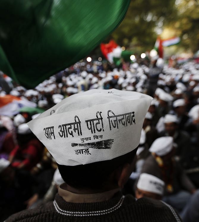 Aam Aadmi Party supporters attend the first party workers meeting after the AAP won 28 seats in the Delhi assembly election.