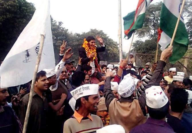 Saurabh Bharadwaj does the politician's equivalent of the rock concert crowd surfing, after his victory from Greater Kailash, New Delhi