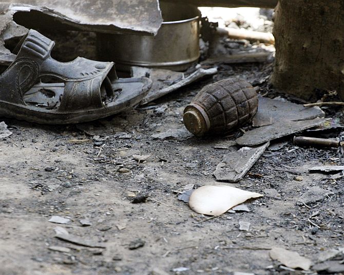 An unexploded grenade lies on the floor of a police camp after a Maoist attack in Rani Bodli village in Chhattisgarh