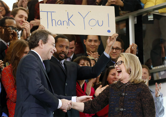Clinton shakes hands with Deputy Secretary of State Thomas Nides as she bids farewell on her last day in office
