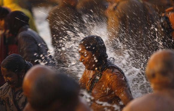 A devotee takes a dip during the second