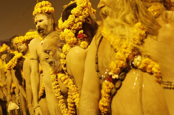 Sadhus line up as they prepare to take a dip during the second