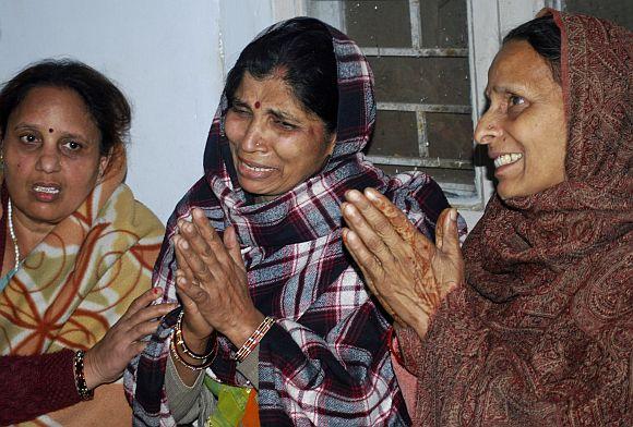 Women grieve for their relatives after part of a railing from a bridge collapsed and triggered a stampede at Allahabad railway station