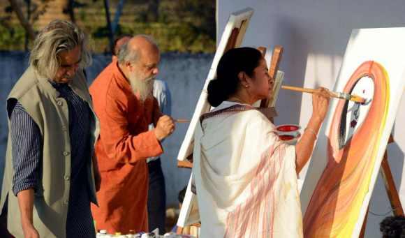 Mamata Banerjee paints during the Maati Utsav in Kolkata