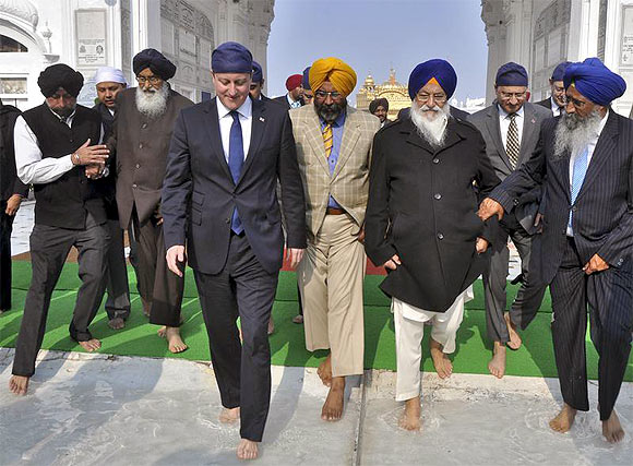 Britain's Prime Minister David Cameron walks inside the premises of the holy Sikh shrine of Golden temple in Amritsar
