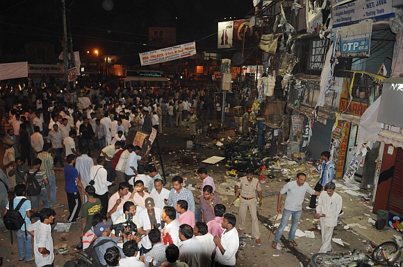 People and media gather after the blasts
