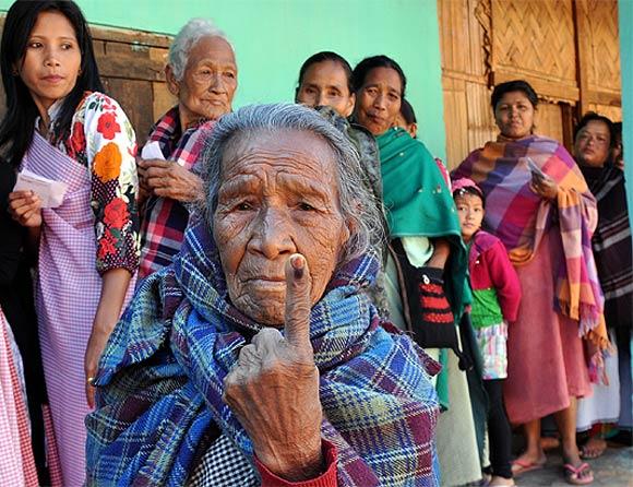 A senior citizen casts shows her inked finger after she cast her vote in Meghalaya