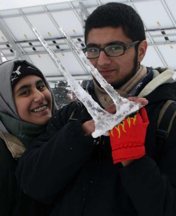 Kashmir tourists pose with icicles