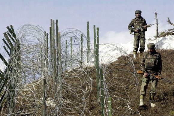 Indian soldiers patrol along the Indo-Pak border