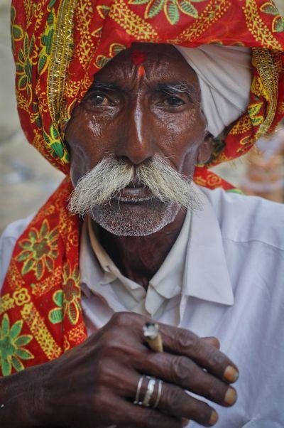 A Hindu devotee holds smokes a bidi after arriving at Shri Hinglaj Mata Temple in Pakistan