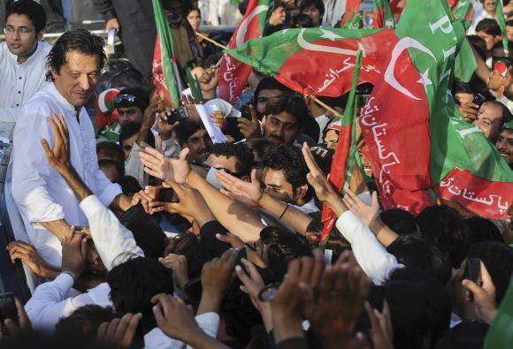 Imran Khan surrounded with supporters as he leads peace march against US drone strikes in Mianwali in October, 2012