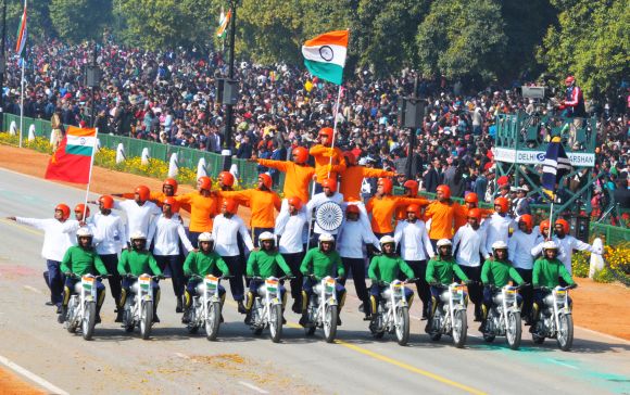Rajpath comes alive with the dare devil stunts of motorbike riders of Border Security Force, during the 64th Republic Day parade.